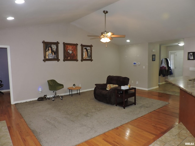 sitting room with ceiling fan, vaulted ceiling, and hardwood / wood-style flooring