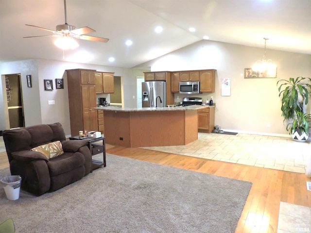 living room featuring ceiling fan with notable chandelier, lofted ceiling, and light hardwood / wood-style flooring