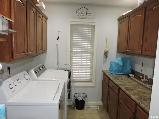 laundry room with cabinets and washing machine and dryer