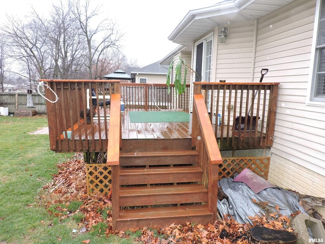 wooden terrace featuring a yard