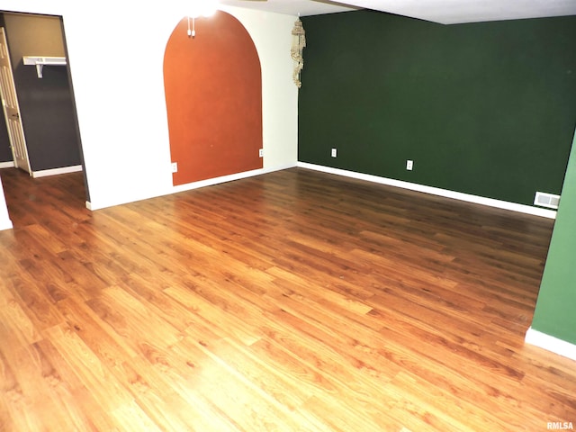 unfurnished room featuring hardwood / wood-style flooring