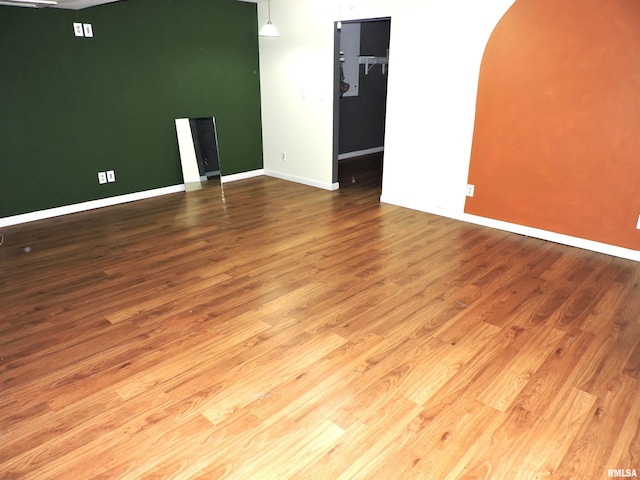 empty room with hardwood / wood-style flooring