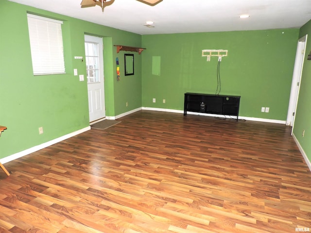 empty room with ceiling fan and wood-type flooring