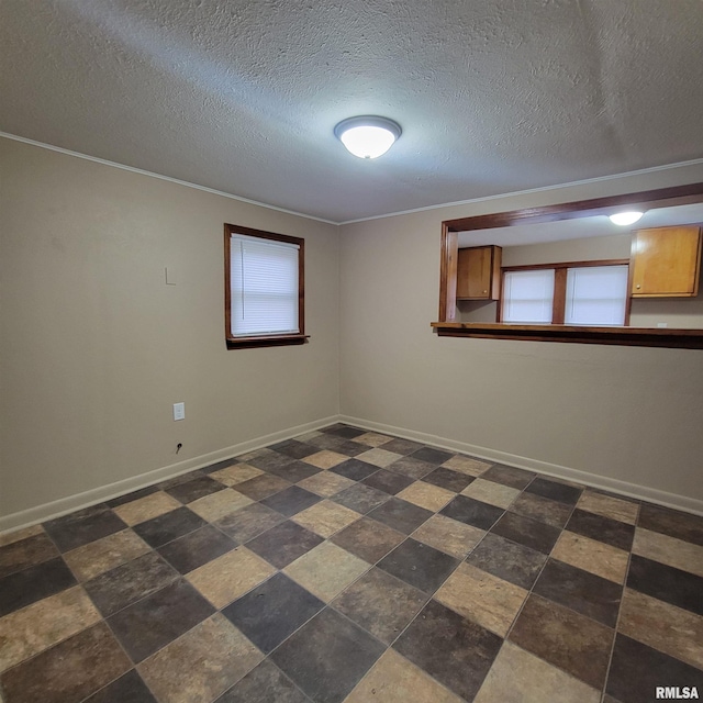 empty room with plenty of natural light and a textured ceiling