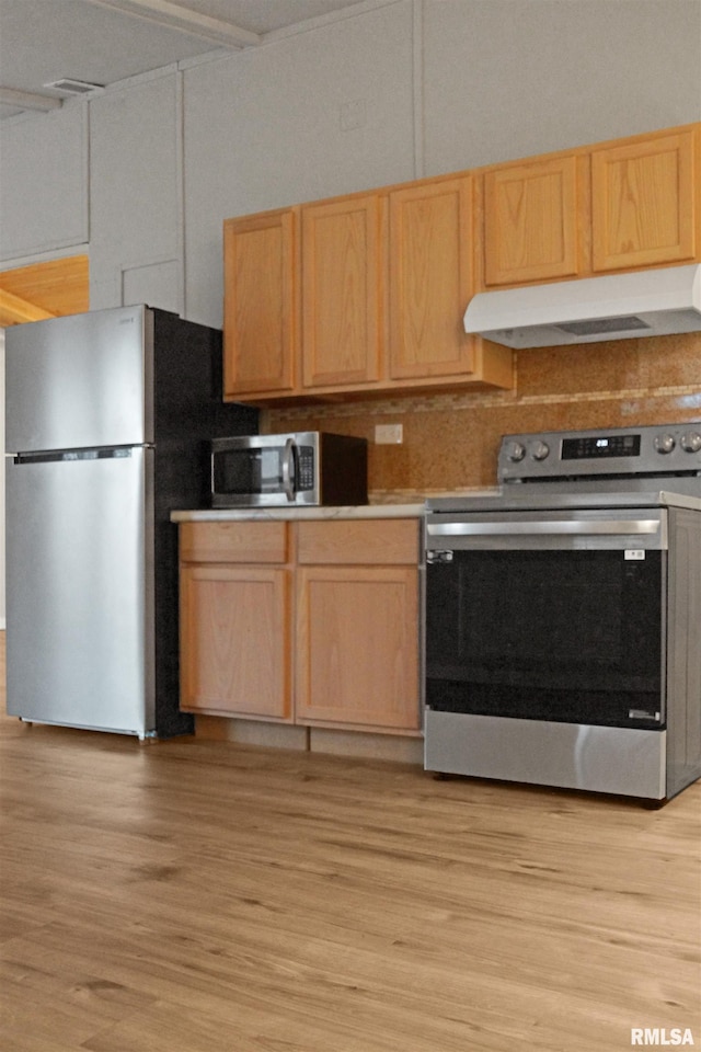 kitchen with light wood-type flooring, stainless steel appliances, and light brown cabinetry