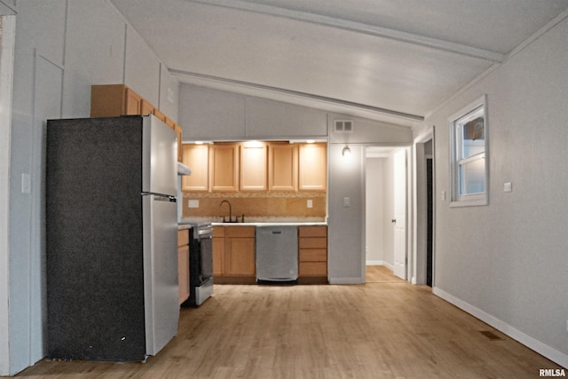 kitchen featuring sink, light hardwood / wood-style flooring, vaulted ceiling with beams, tasteful backsplash, and stainless steel appliances