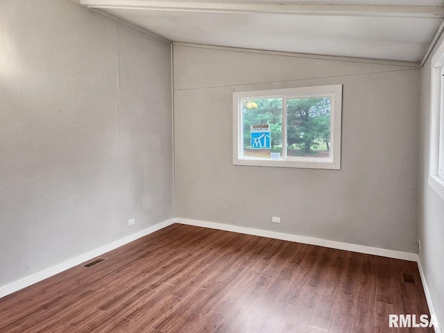 empty room featuring hardwood / wood-style floors and lofted ceiling