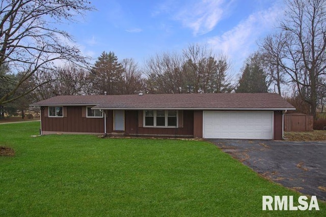 ranch-style house with a garage and a front lawn