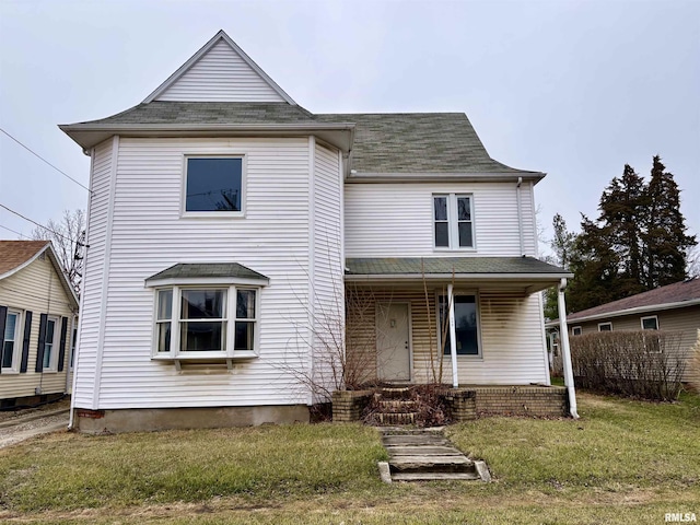 view of front of house with covered porch and a front lawn