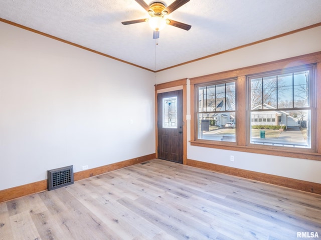 entryway featuring a textured ceiling, ceiling fan, light wood-type flooring, and crown molding