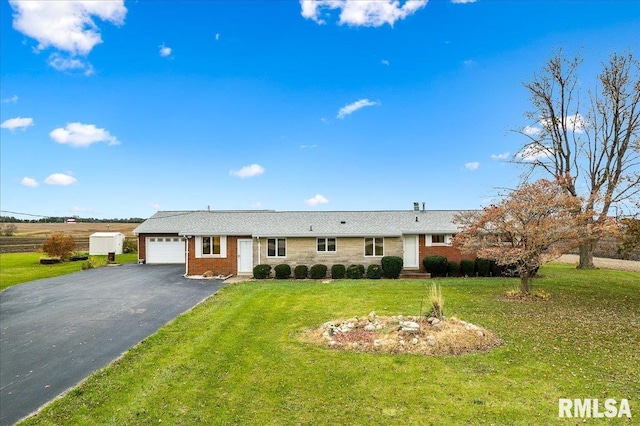 single story home featuring a garage and a front lawn