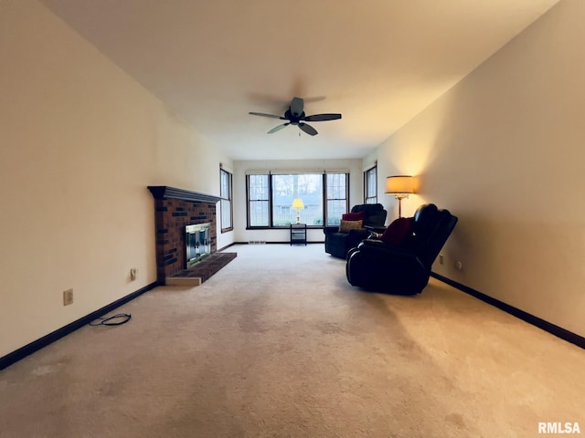 living area with carpet flooring, ceiling fan, and a brick fireplace