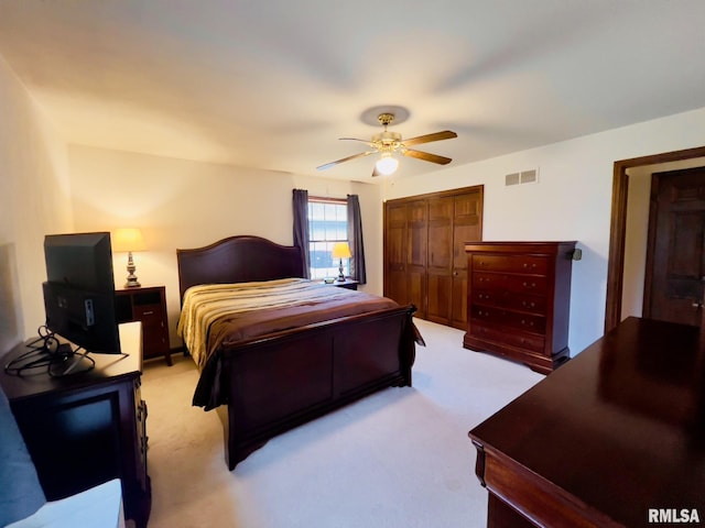 carpeted bedroom with a closet and ceiling fan