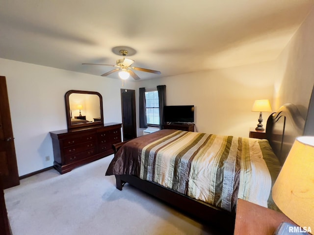 bedroom with ceiling fan and light colored carpet