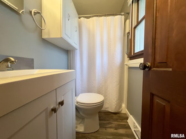 bathroom with a shower with shower curtain, vanity, hardwood / wood-style flooring, and toilet