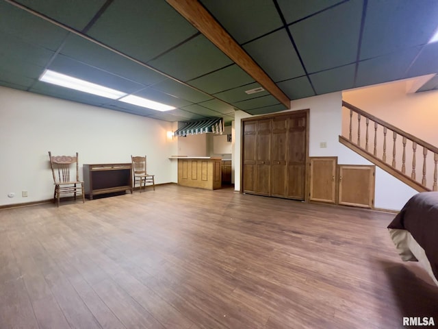 basement featuring hardwood / wood-style flooring and a drop ceiling