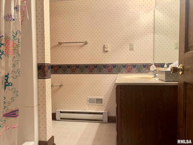 bathroom featuring vanity and baseboard heating