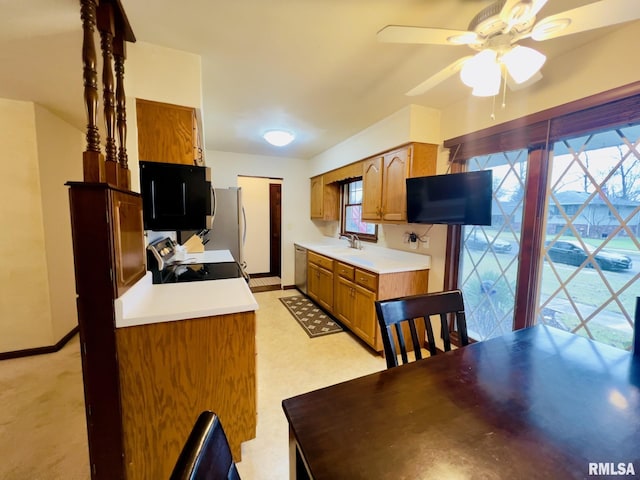 kitchen featuring ceiling fan, sink, stainless steel appliances, and plenty of natural light