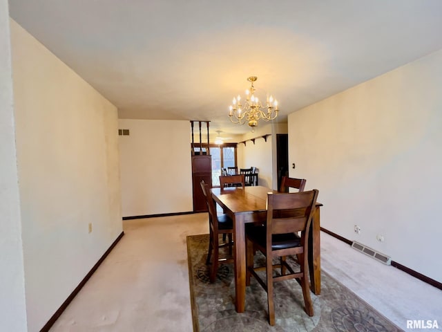 carpeted dining area with an inviting chandelier