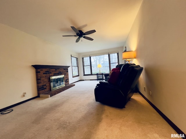 carpeted living room with ceiling fan and a fireplace