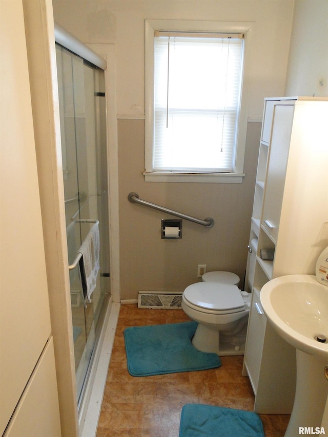 bathroom with toilet and walk in shower