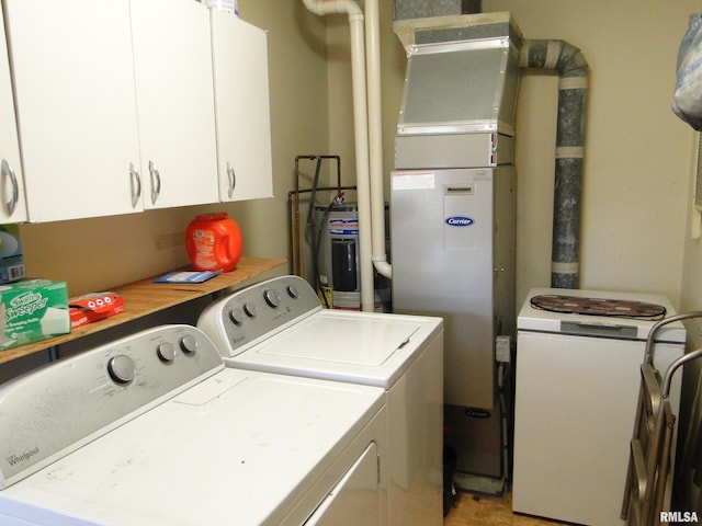 washroom featuring washer and clothes dryer and cabinets