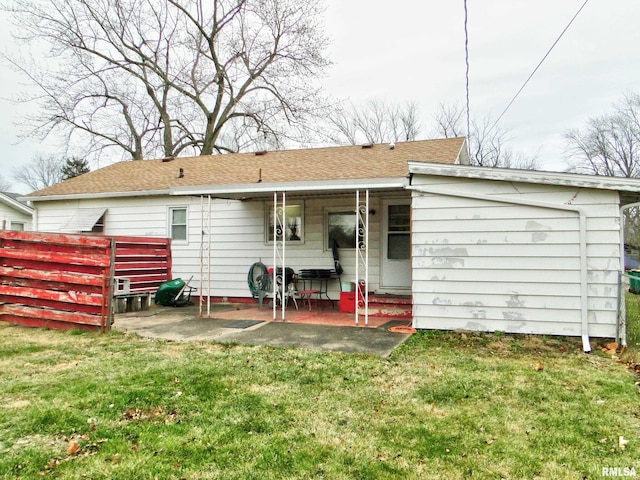 back of house with a lawn and a patio