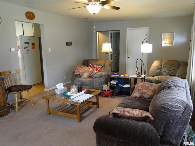 carpeted living room featuring ceiling fan