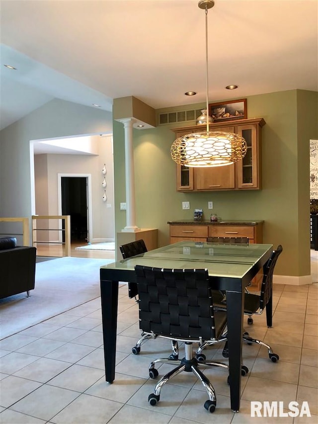 tiled dining space with vaulted ceiling