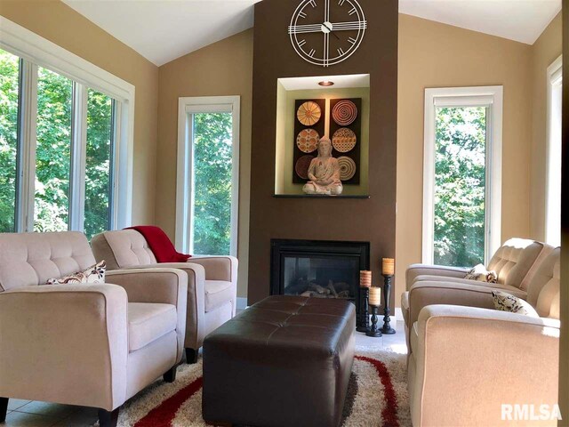 living area with a wealth of natural light and vaulted ceiling