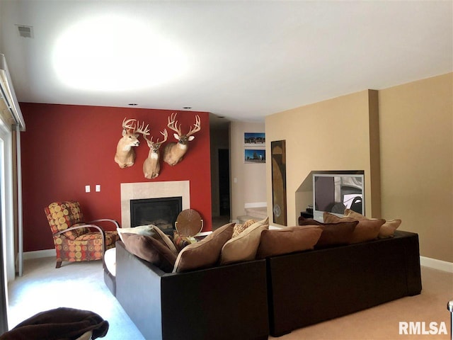 living room featuring carpet flooring and a fireplace