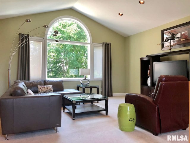 living room featuring light colored carpet, plenty of natural light, and lofted ceiling