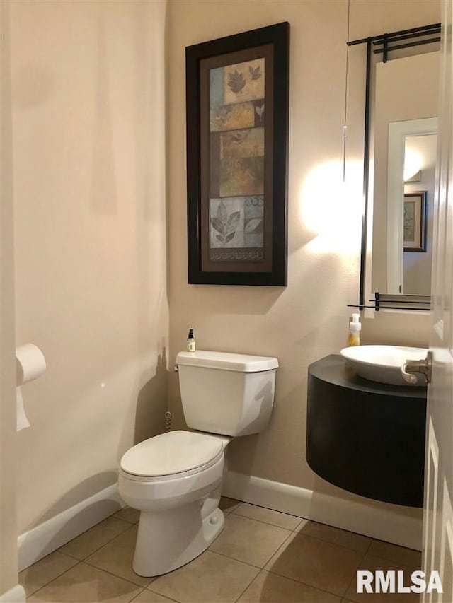 bathroom featuring tile patterned flooring, vanity, and toilet