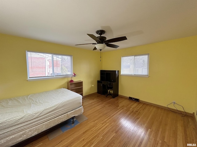 bedroom with ceiling fan and hardwood / wood-style flooring