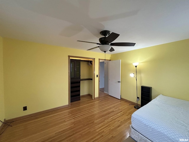 bedroom featuring wood-type flooring and ceiling fan