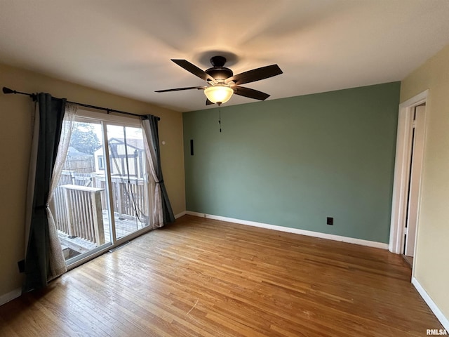 empty room featuring ceiling fan and hardwood / wood-style floors