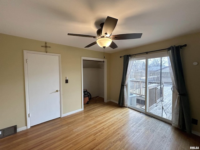 unfurnished bedroom with access to exterior, a closet, ceiling fan, and light hardwood / wood-style floors