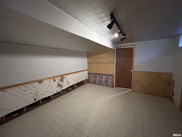 additional living space featuring a textured ceiling