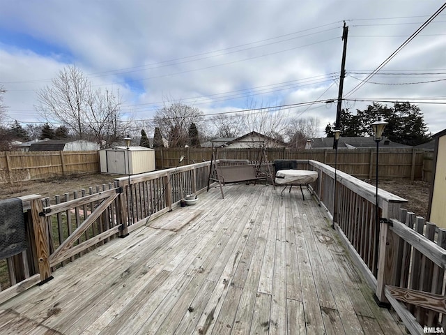 wooden deck with a storage shed