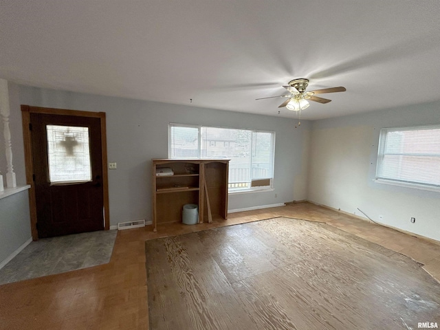 unfurnished living room featuring ceiling fan and light wood-type flooring