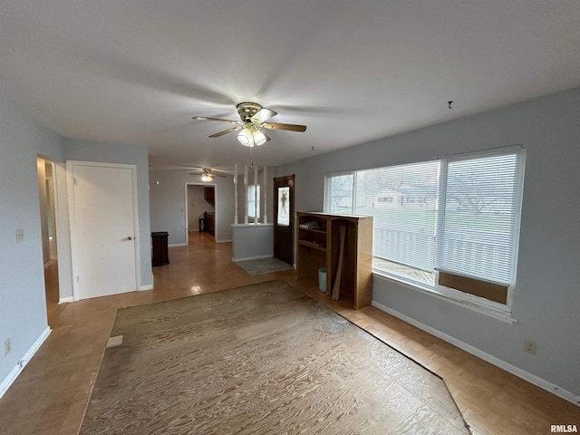 unfurnished living room featuring ceiling fan