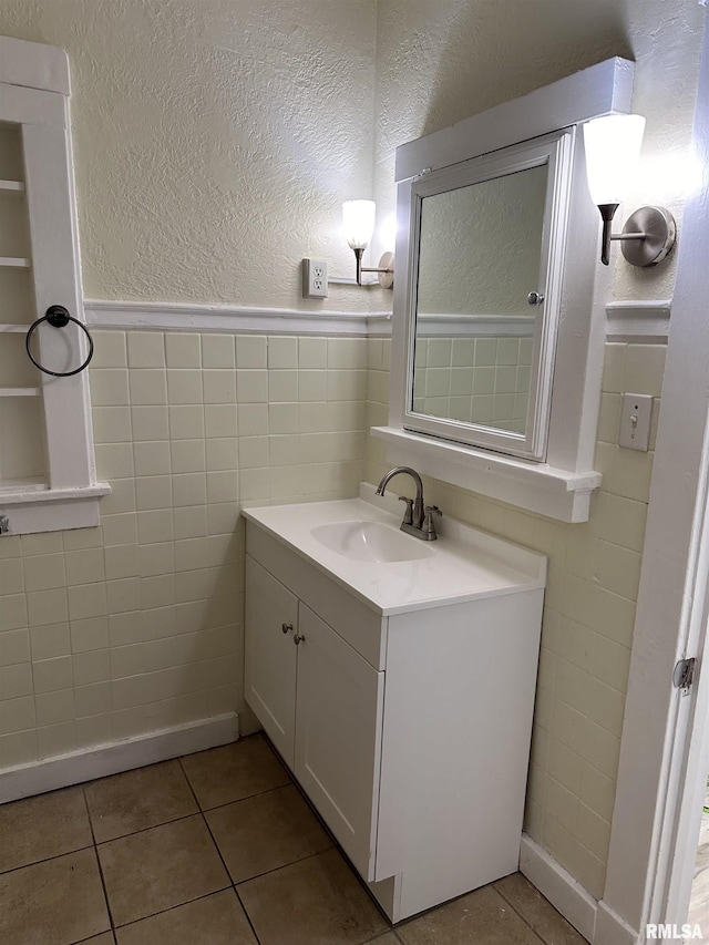 bathroom featuring tile patterned floors, vanity, and tile walls