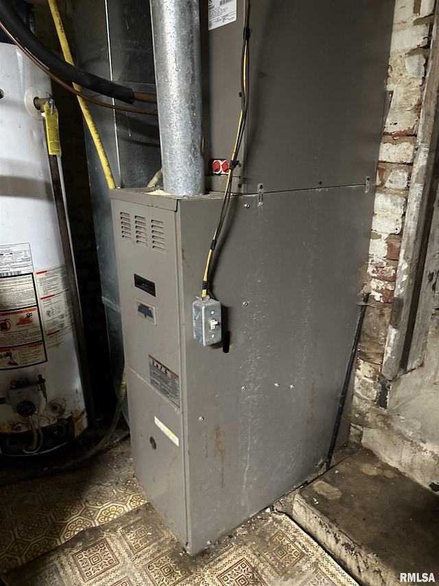 utility room featuring heating unit and water heater