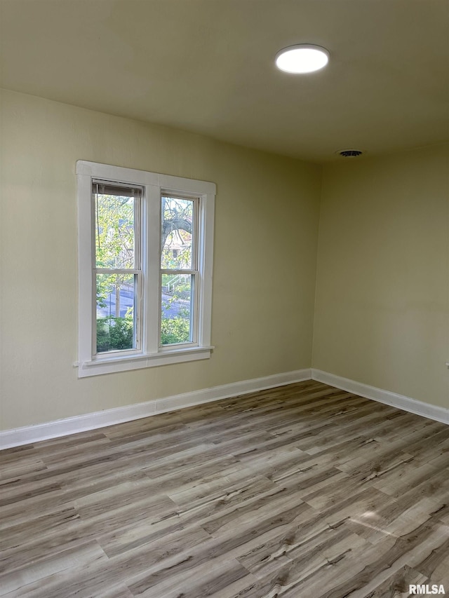 spare room with light hardwood / wood-style flooring