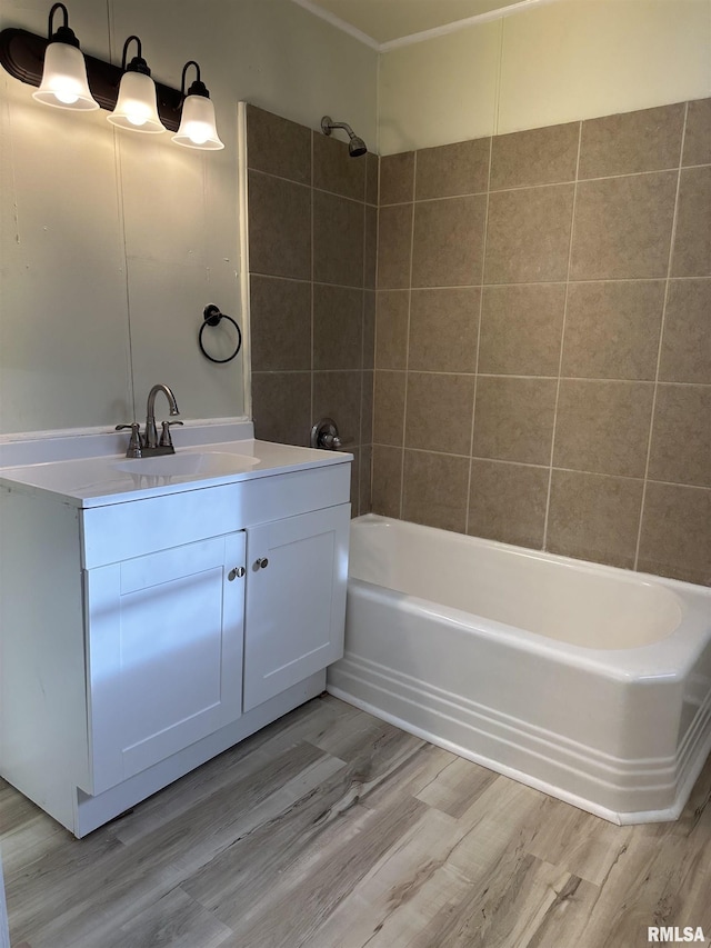 bathroom with shower / bathing tub combination, hardwood / wood-style floors, and vanity