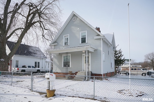 view of snow covered rear of property