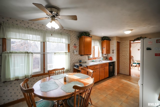 dining room featuring ceiling fan and sink