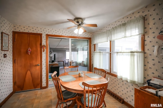 tiled dining room featuring ceiling fan