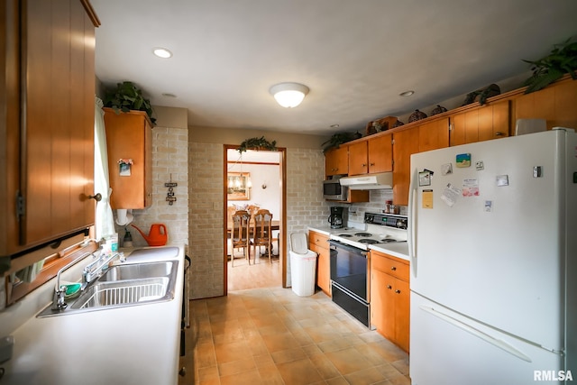 kitchen featuring decorative backsplash, sink, and white appliances