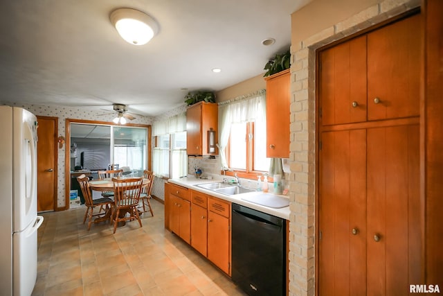 kitchen featuring sink, ceiling fan, decorative backsplash, black dishwasher, and white fridge